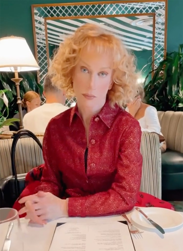 kathy griffin looking serious at a restaurant table