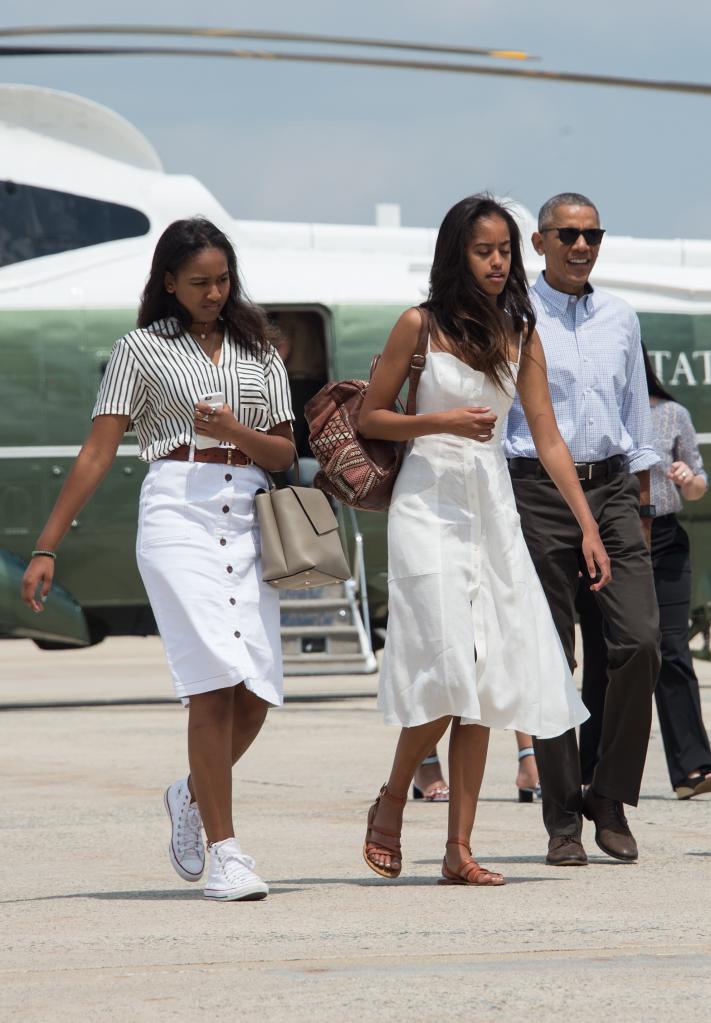 Sasha and Malia Obama and their father, Barack Obama.