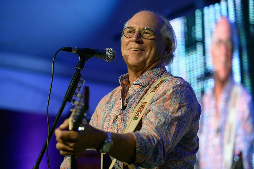 Jimmy Buffett performing on stage. 