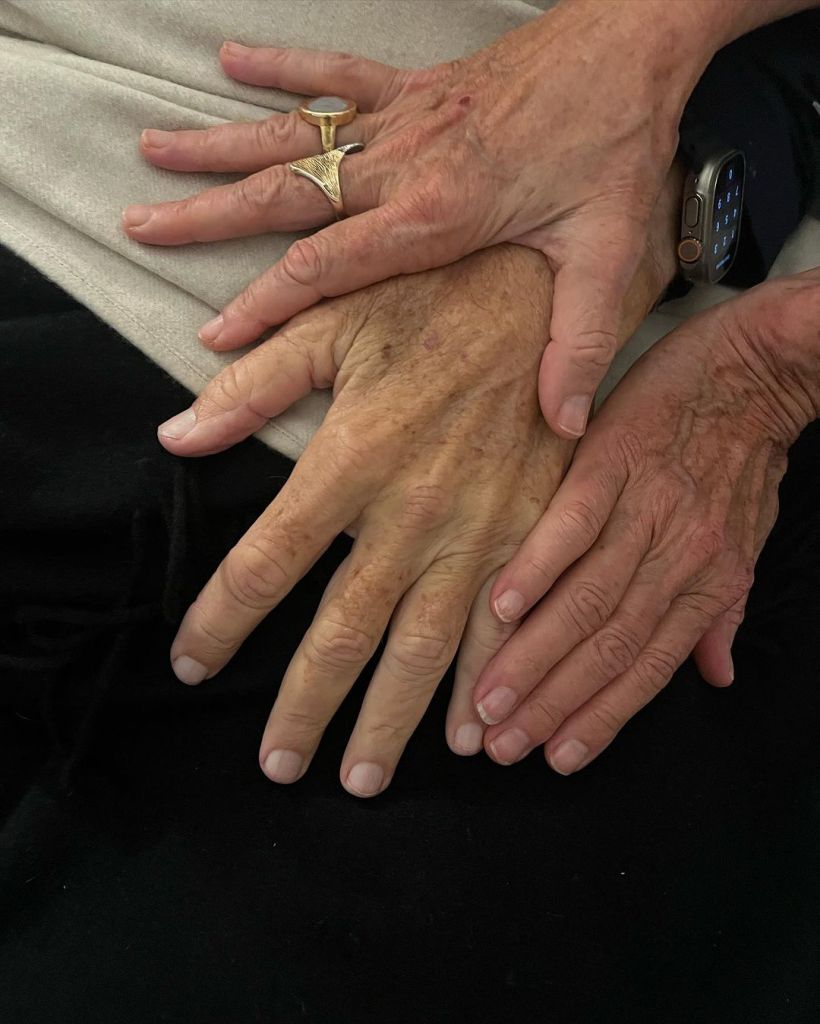 Laurie holding Jimmy Buffett's hand.