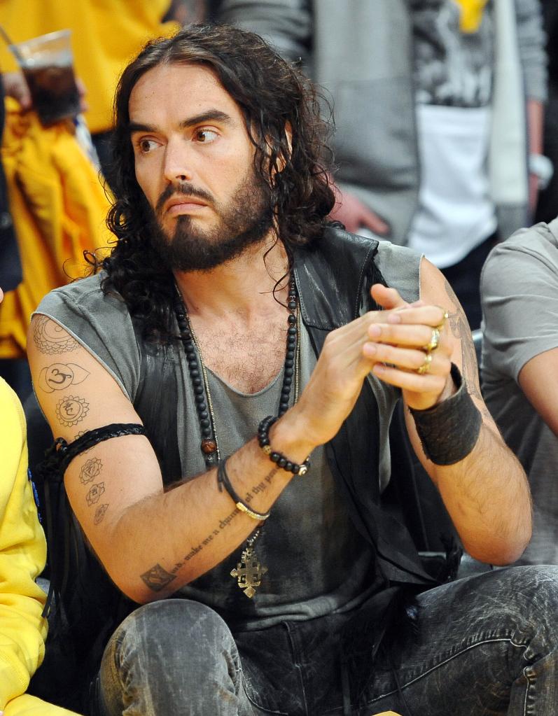 Russell Brand sitting courtside.