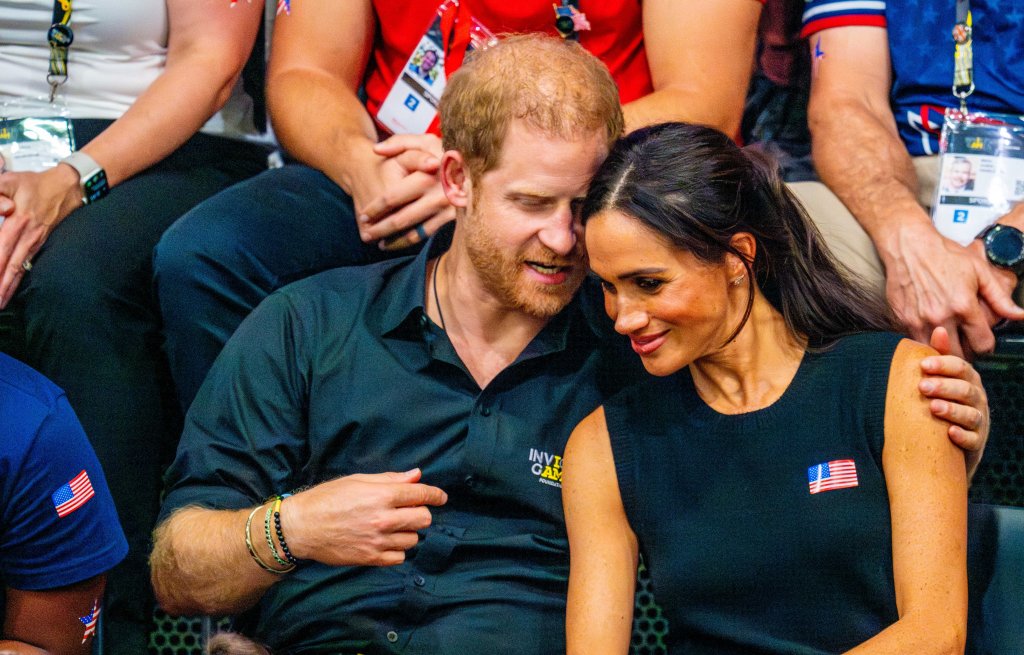 Meghan Markle and Prince Harry showing PDA at the 2023 Invictus Games. 