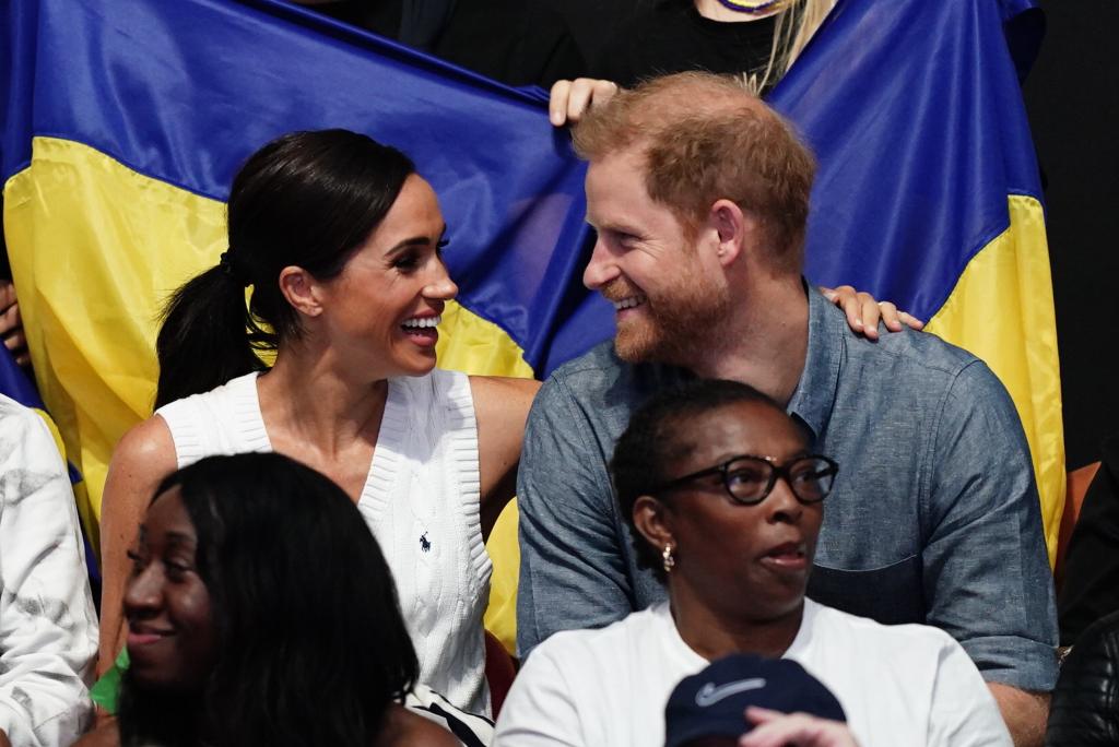 Meghan Markle and Prince Harry showing PDA at the 2023 Invictus Games. 