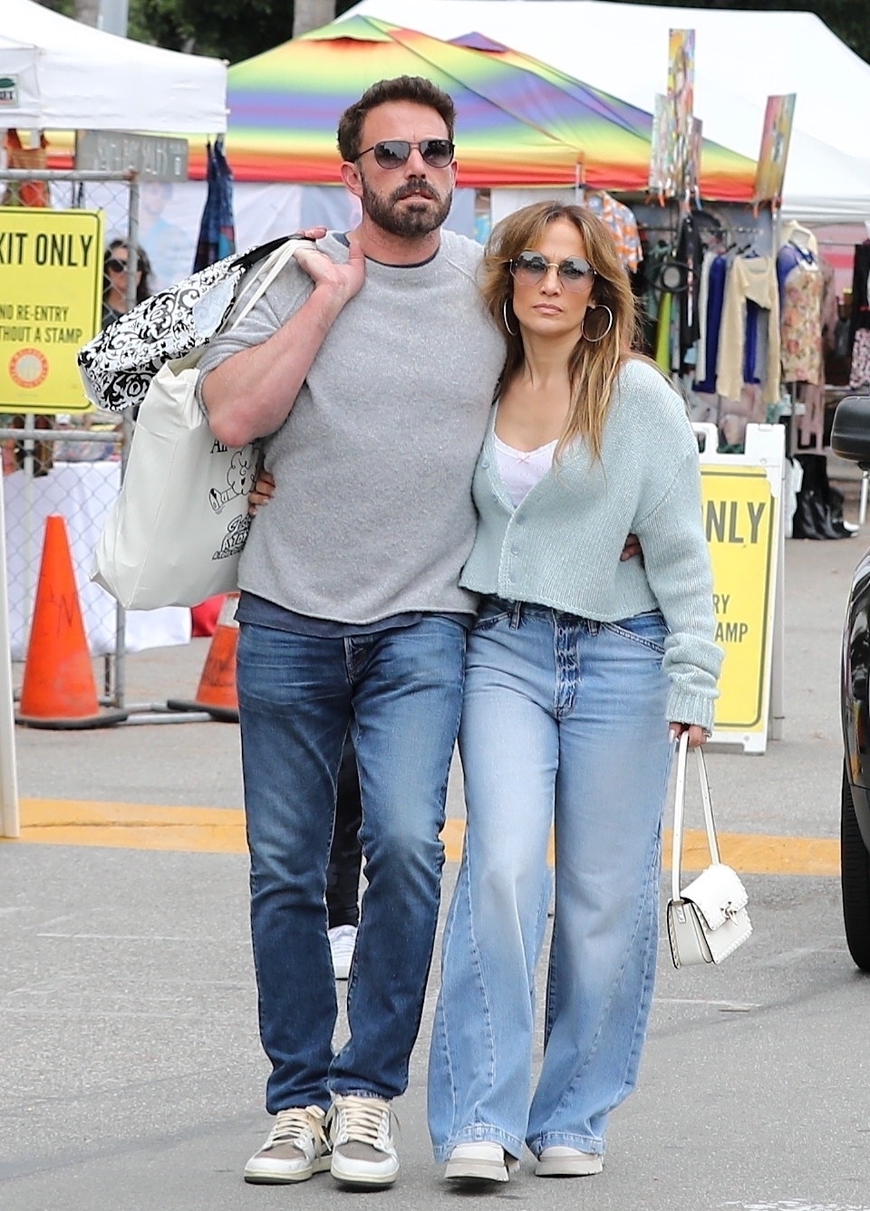 Jennifer Lopez and Ben Affleck walking through a flea market