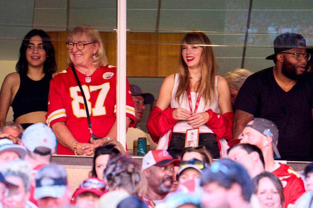 Taylor Swift cheering from a suite with Donna Kelce.