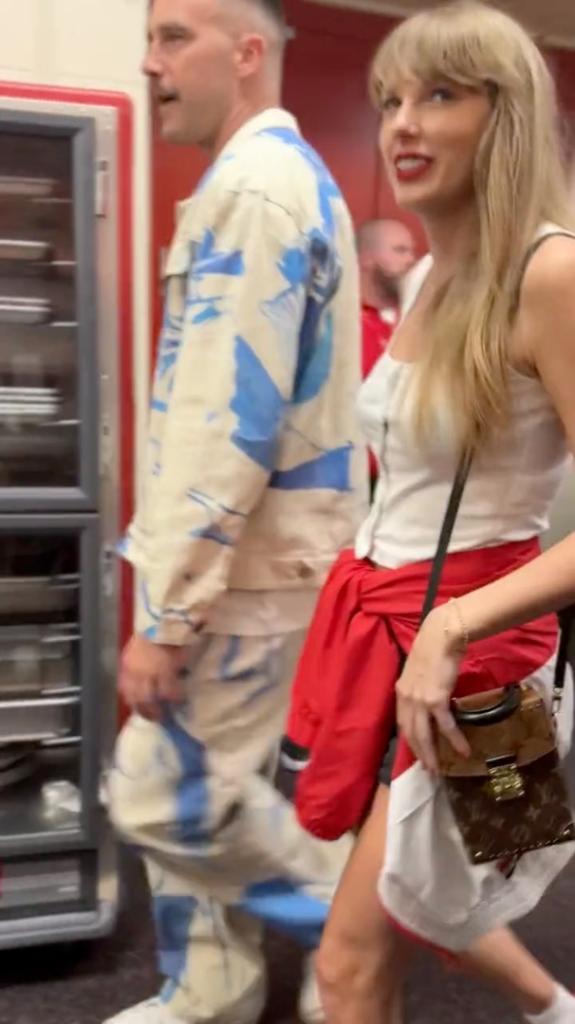Travis Kelce and Taylor Swift leaving an NFL game together.