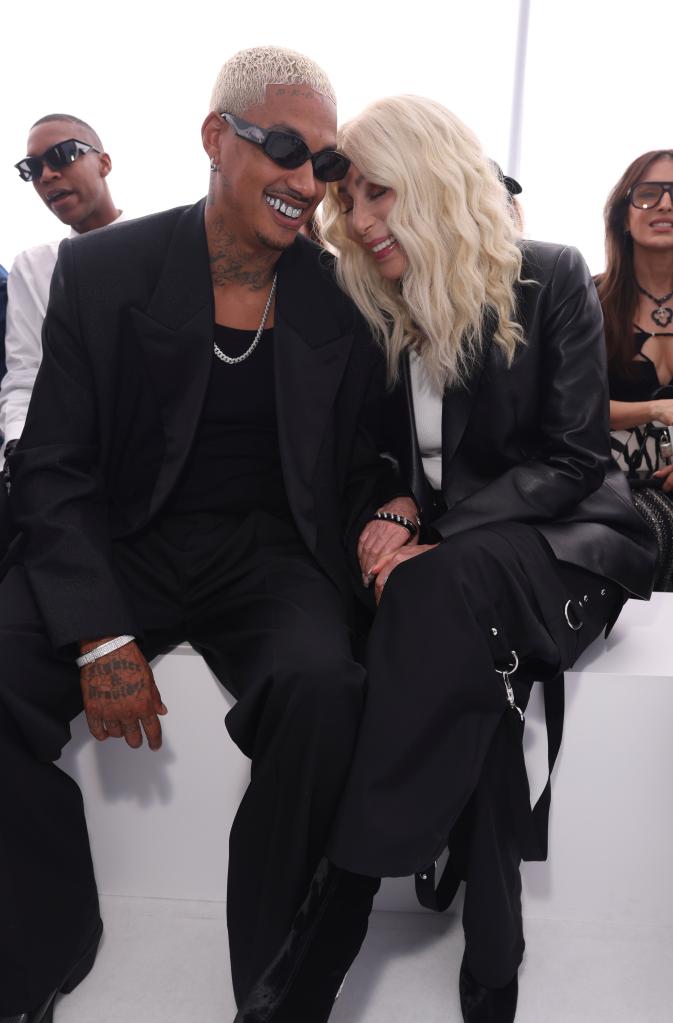 Cher and Alexander Edwards smiling at Paris Fashion show.