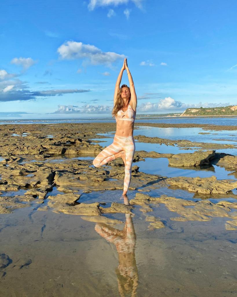 gisele bundchen in a flamingo pose on the beach