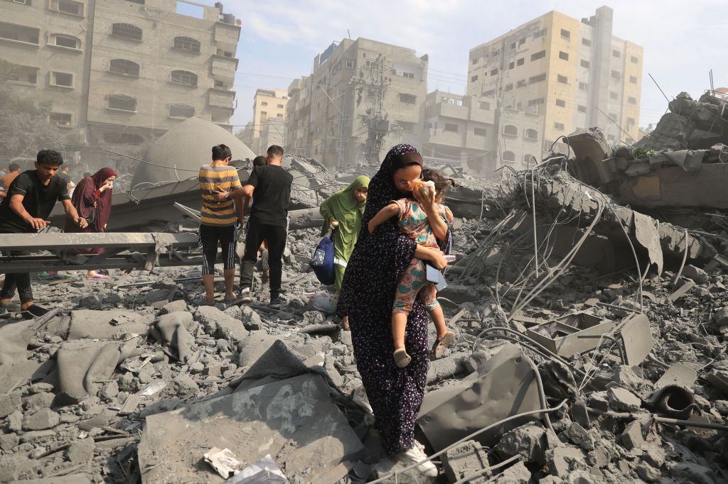 Palestinians evacuating an area that was hit by an air strike