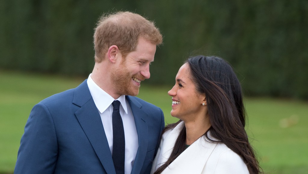 Meghan Markle and Prince Harry smiling at each other.