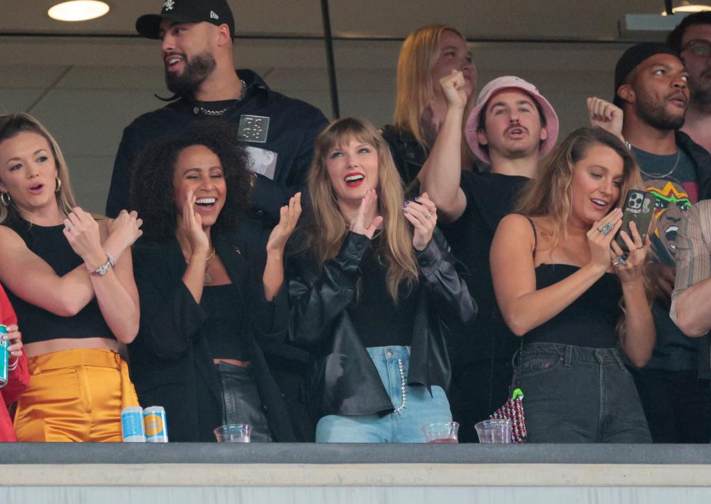 taylor swift, blake lively and more people clapping in a stadium box