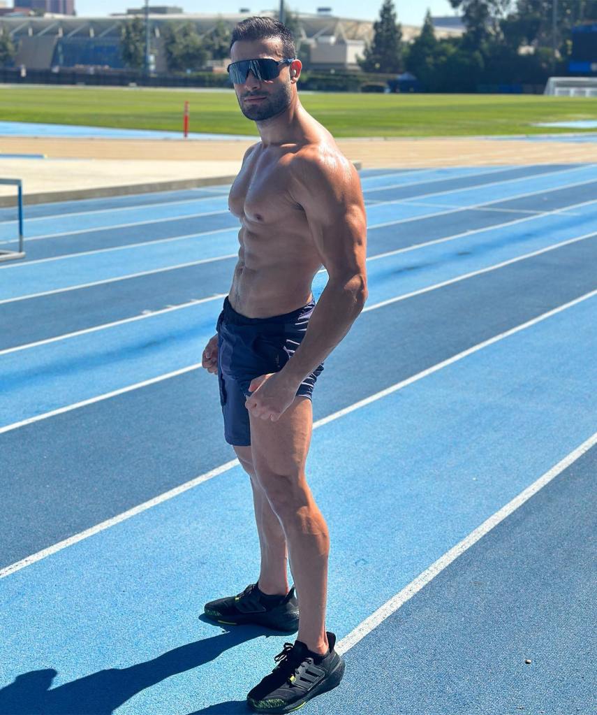 shirtless sam asghari standing on a track