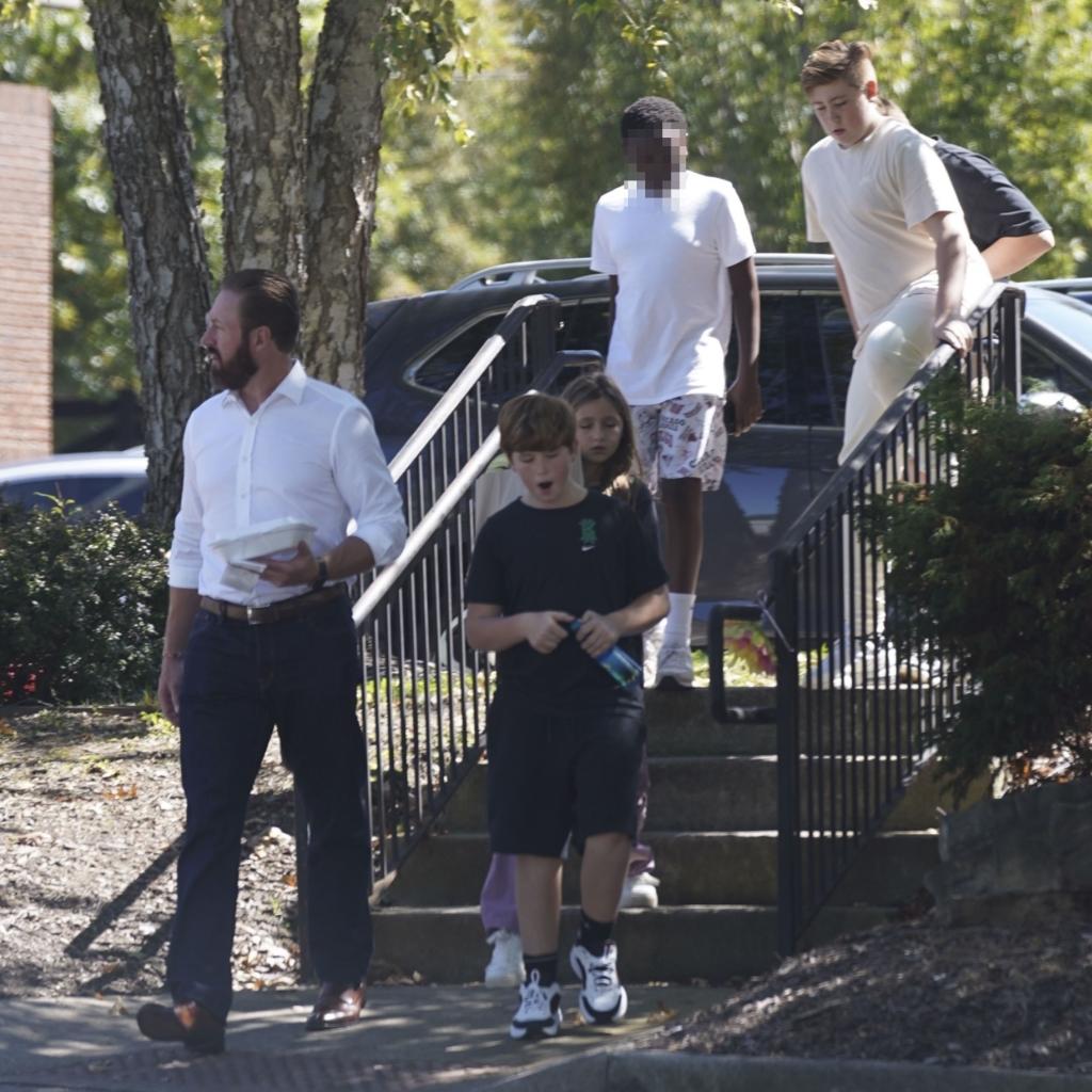 kroy biermann with a full beard walking with his four kids