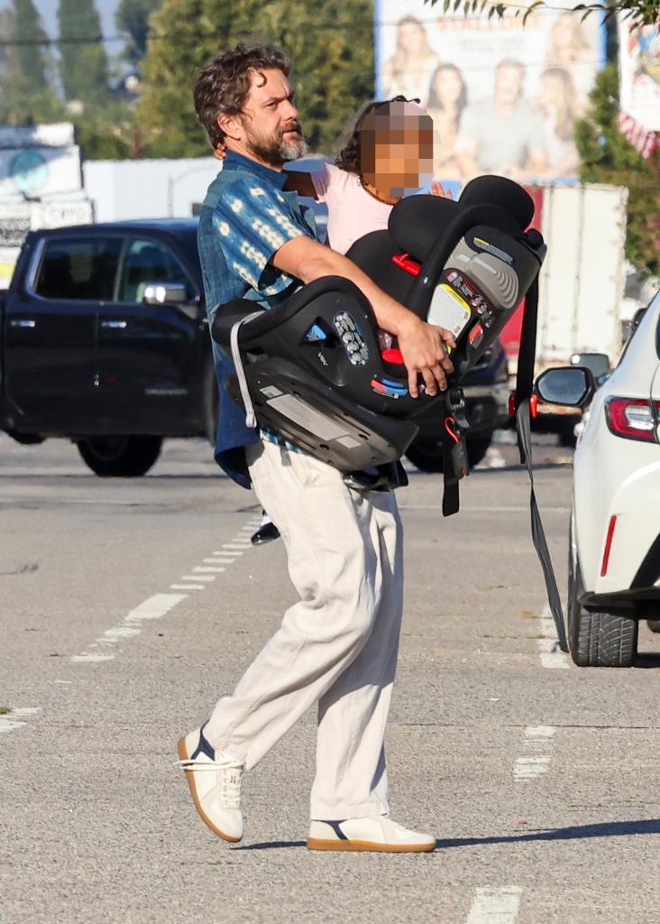 Joshua Jackson holding up his daughter