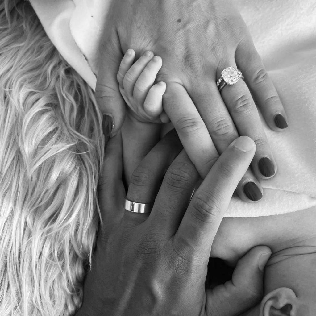 Becca Kufrin and Thomas Jacobs black and white of their hands.