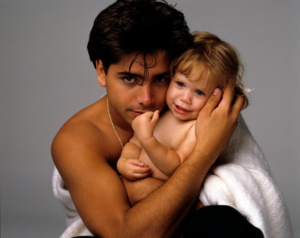 John Stamos and one of the Olsen twins as a baby.
