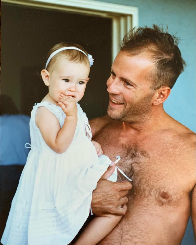 Rumer Willis as a baby being held by Bruce Willis