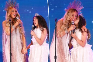 Mariah Carey and her daughter, Monroe Cannon, performing at a holiday concert.