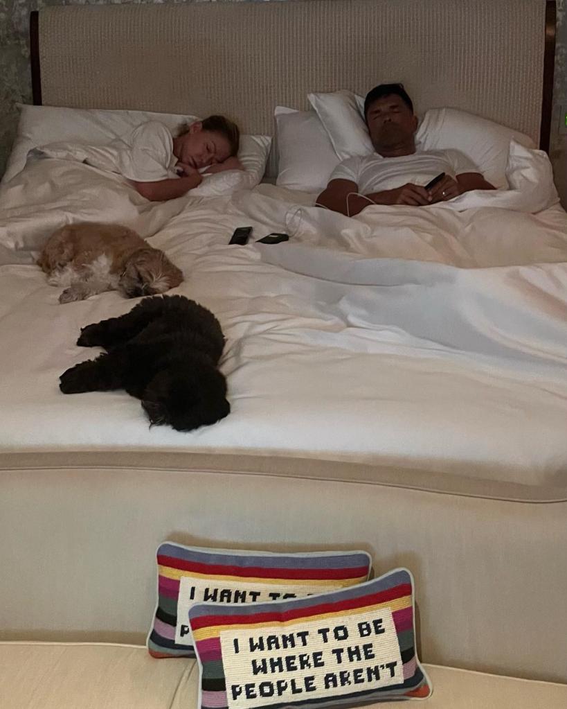 Kelly Ripa and Mark Consuelos sleeping in a bed together