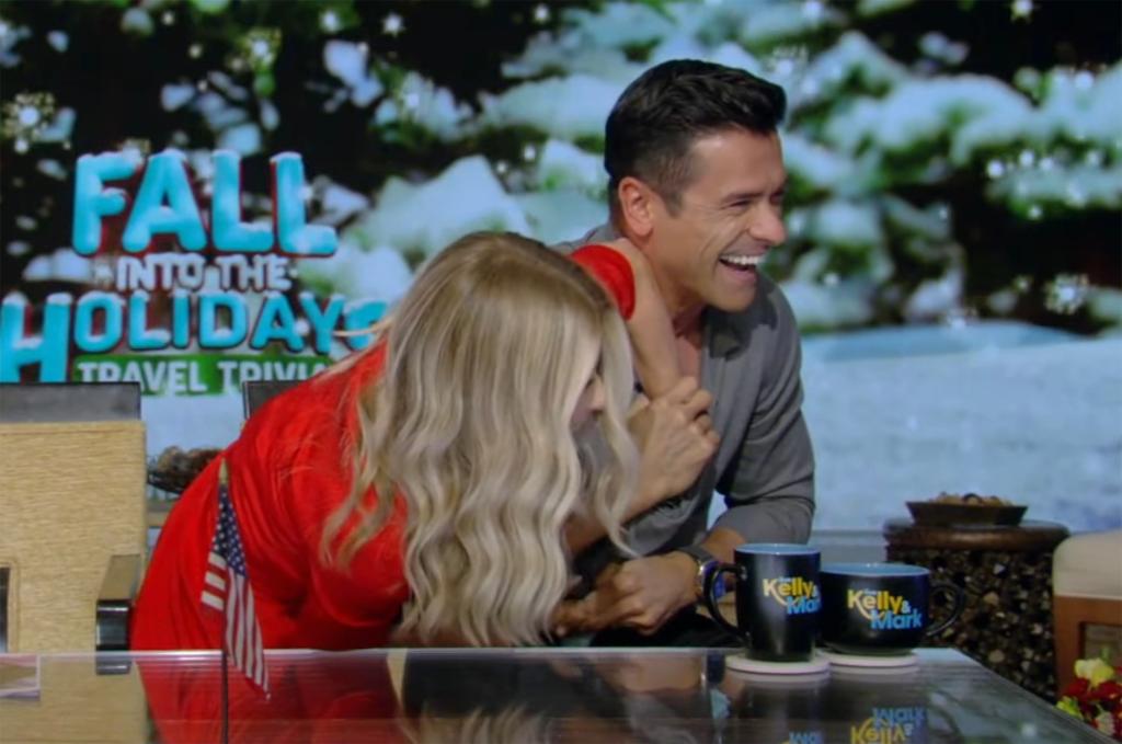 Kelly Ripa with her hand down Mark Consuelos' shirt on "Live"