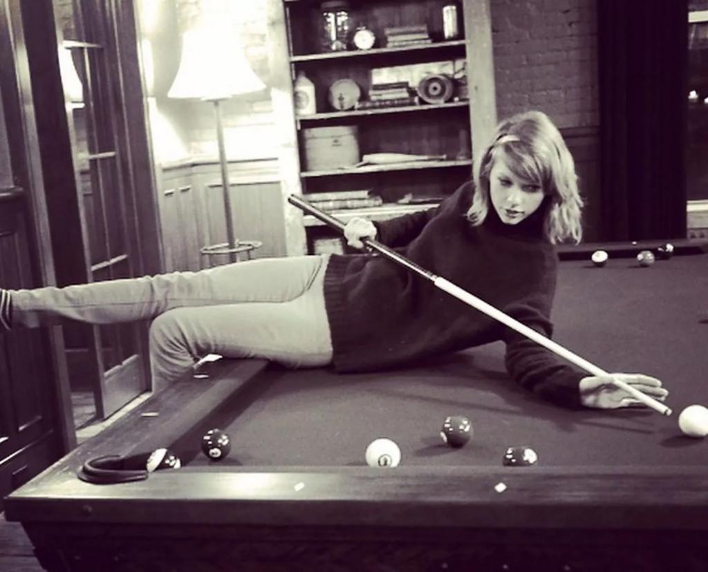 Taylor Swift on her pool table. 