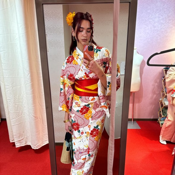 Dua Lipa taking a mirror selfie in traditional Japanese robes