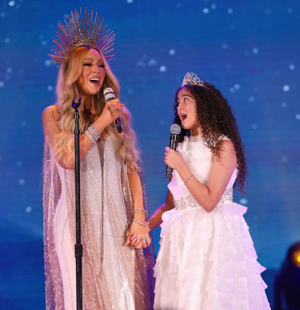 Mariah Carey and her daughter, Monroe Cannon, performing at a holiday concert.