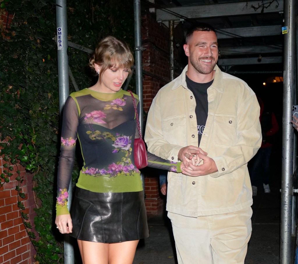 Travis Kelce and Taylor Swift  walking