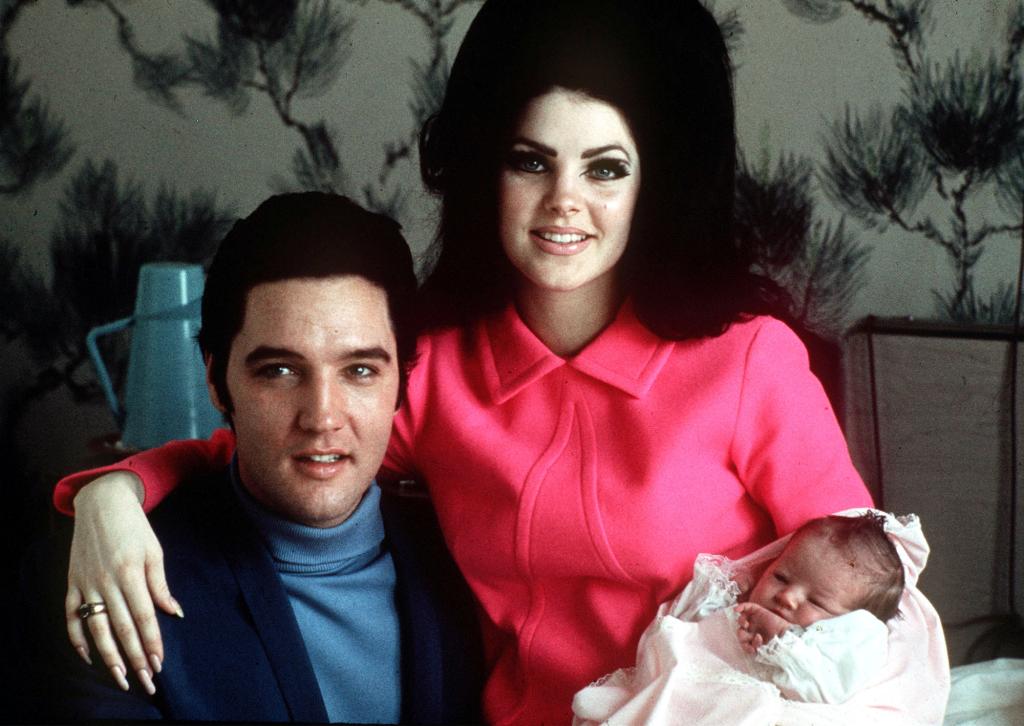 lvis Presley poses with wife Priscilla and daughter Lisa Marie