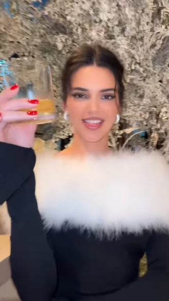 Kendall Jenner sips a cocktail at the Kardashian Family christmas party 2023