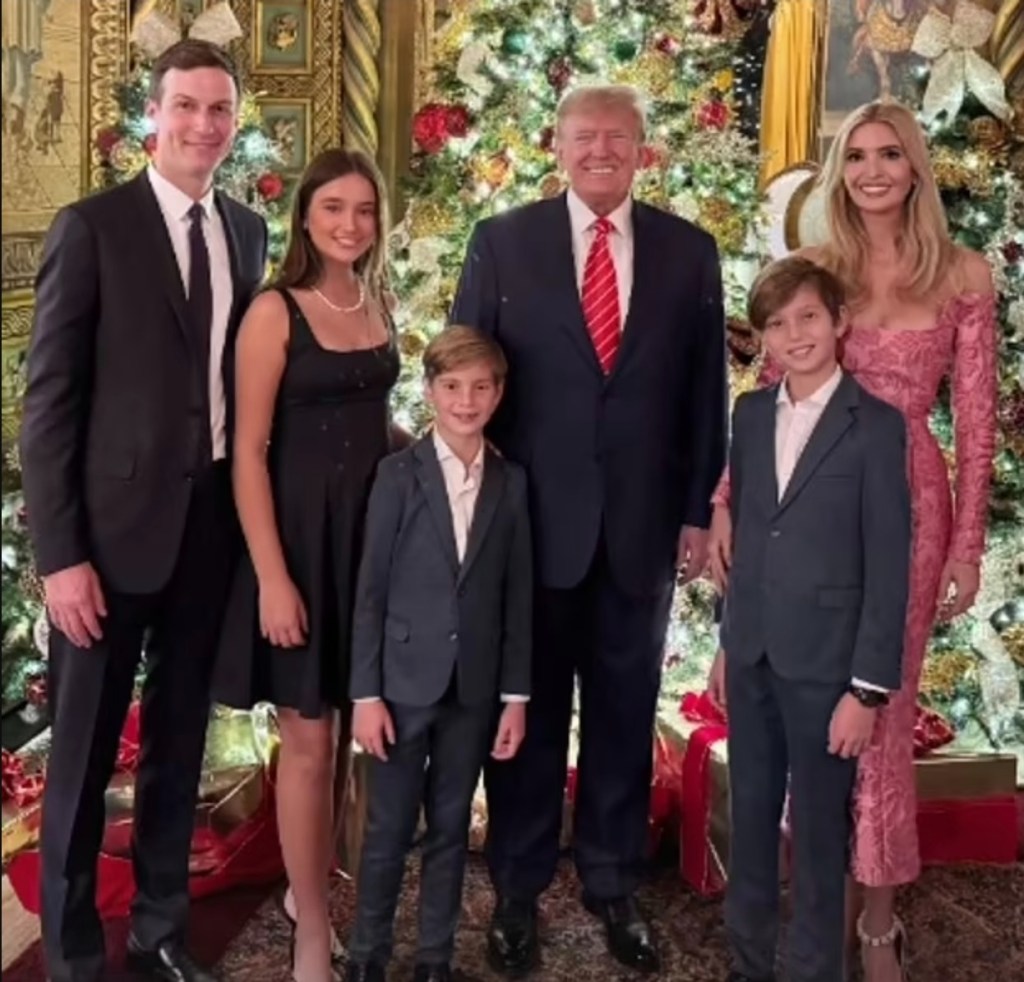 jared kushner, donald trump, ivanka trump and her kids posing in front of the christmas tree