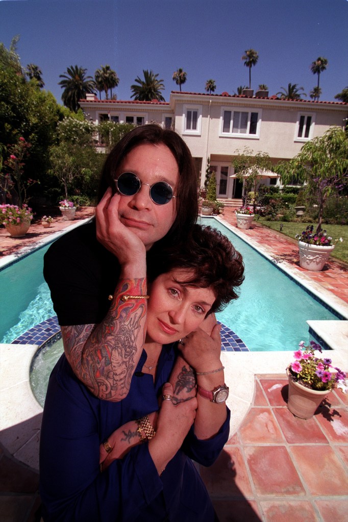 ozzy osbourne leaning on sharon in front of a pool