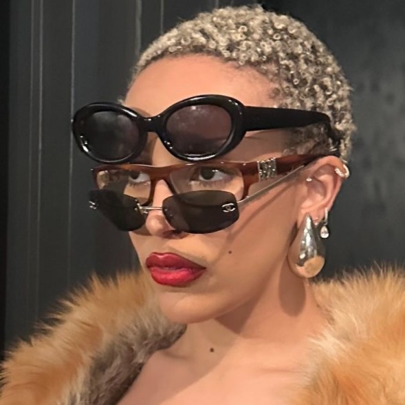 doja cat with three pairs of sunglasses on her face