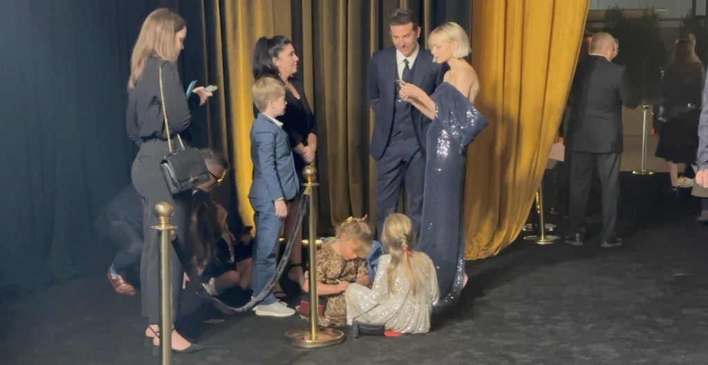 Los Angeles, CA  - Actor Bradley Cooper's daughter is seen taking a break from the red carpet to get down for some good ol coloring time! The actor bought daughter Lea De Seine to the LA premiere of his latest project, Maestro and though the 6 year old was all smiles as she posed with her famous dad briefly she could be seen hanging with another young girl closer to her own age and enjoying some time drawing on some paper propped on their laps. Note: no devices!

