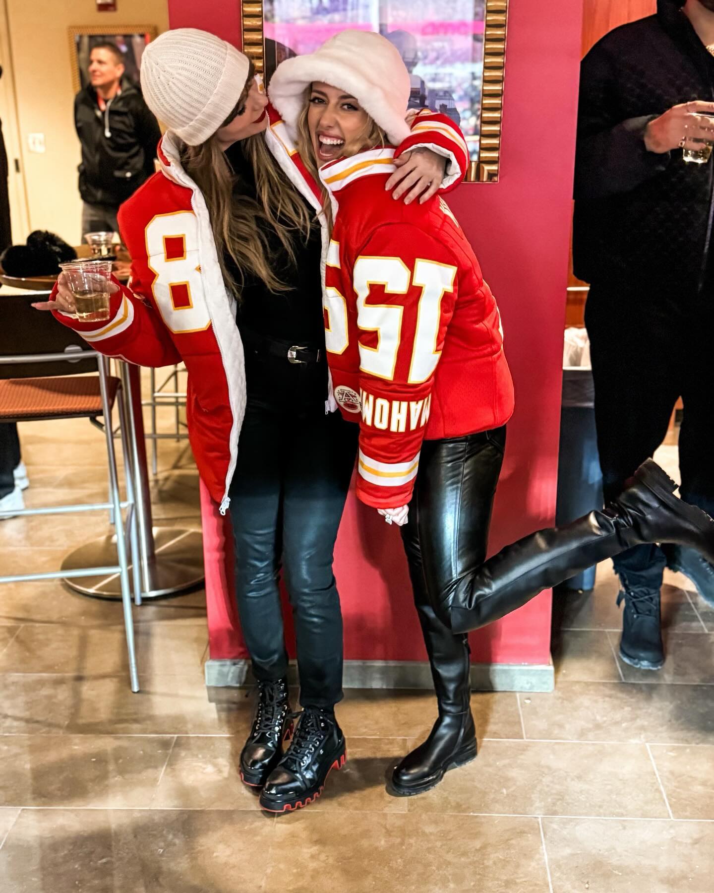 Taylor Swift and Brittany Mahomes in matching coats designed by Kristin Juszczyk.