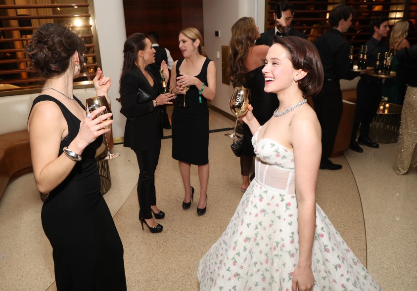 Cailee Spaeny holding champagne