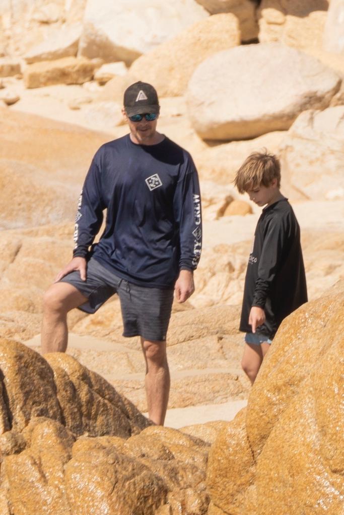 Christian Bale and his son on the beach.
