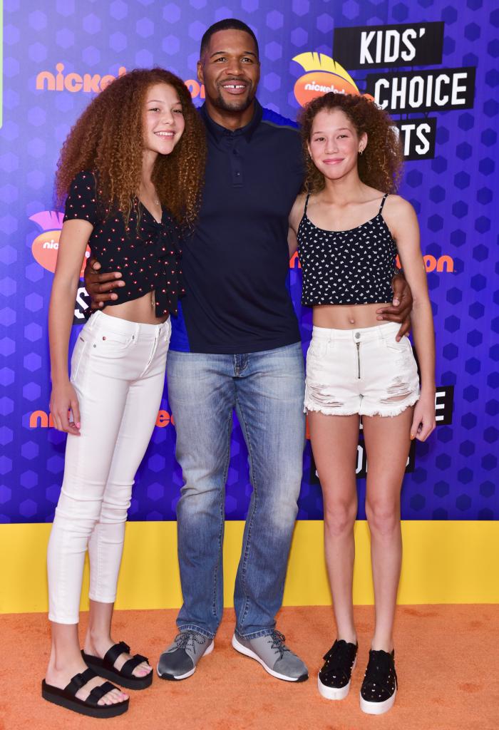 michael strahan posing with his twin daughters isabella and sophia