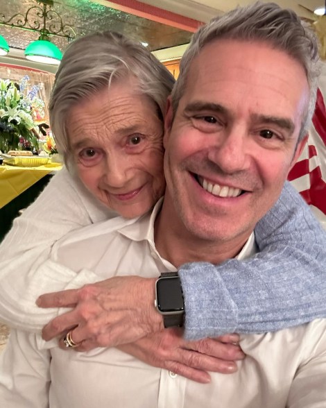 selfie of andy cohen and his mom who has her arms wrapped around him