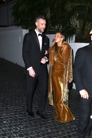 Jennifer Lawrence, accompanied by Cooke Maroney, exits the Golden Globes after party at Chateau Marmont. She looked stunning in her golden velvet gown.