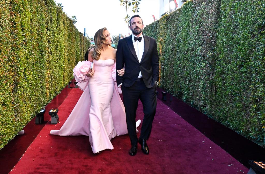 Jennifer Lopez and Ben Affleck walking at the Golden Globes 2024