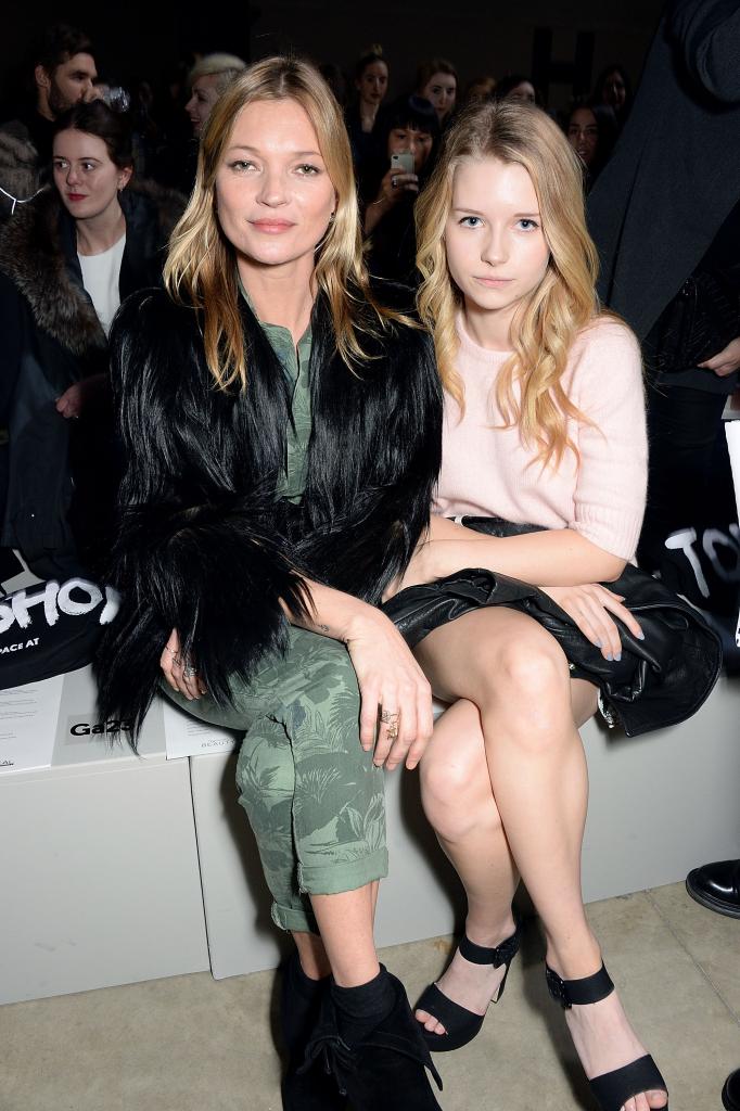 Kate Moss and Lottie Moss sitting together at a fashion show.