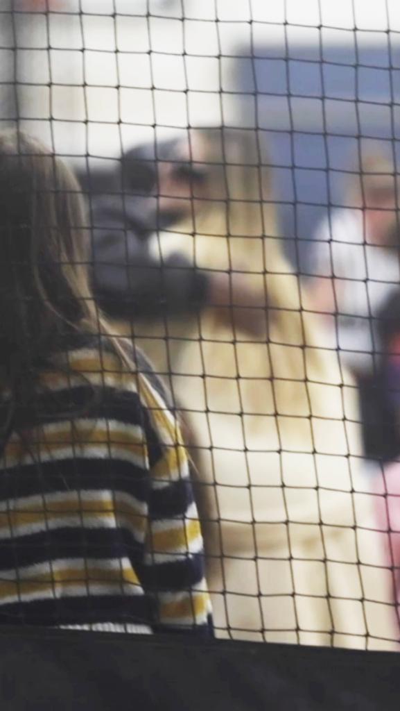 Kanye West and Khloé Kardashian hugging at Saint West's basketball game.