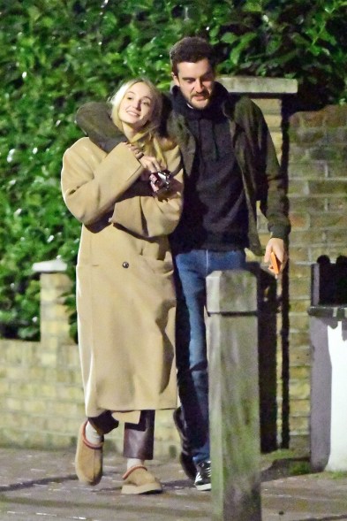 NIPPING OUT: Sophie Turner keeps warm in the streets of London with new beau Peregrine Pearson — and some tiny bottles of booze.