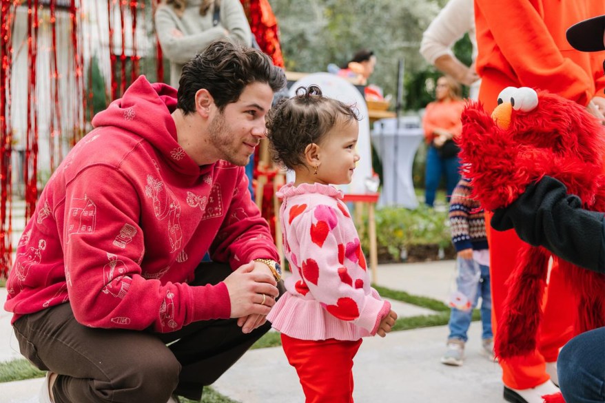 'TICKLE ME' TOT: For daughter Malti’s second birthday, Nick Jonas puts Elmo to work.