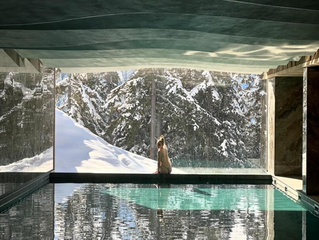 Sophie Turner sitting by a pool in a bikini