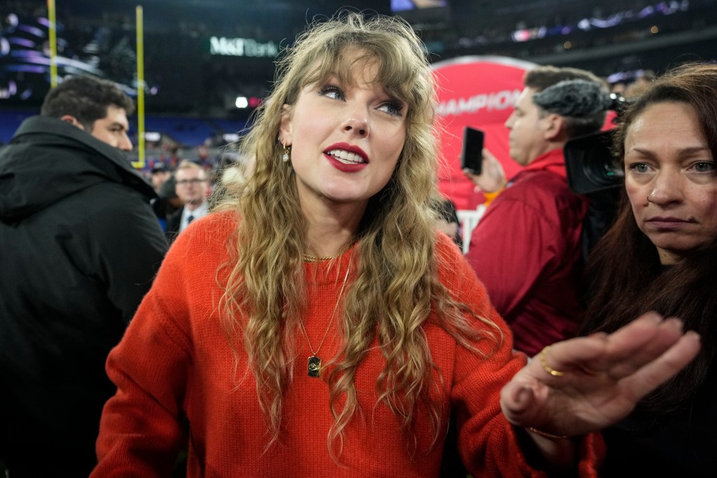 Taylor Swift speaks with people on the field after an AFC Championship NFL football game between the Baltimore Ravens and the Kansas City Chiefs, Sunday, Jan. 28, 2024, in Baltimore.