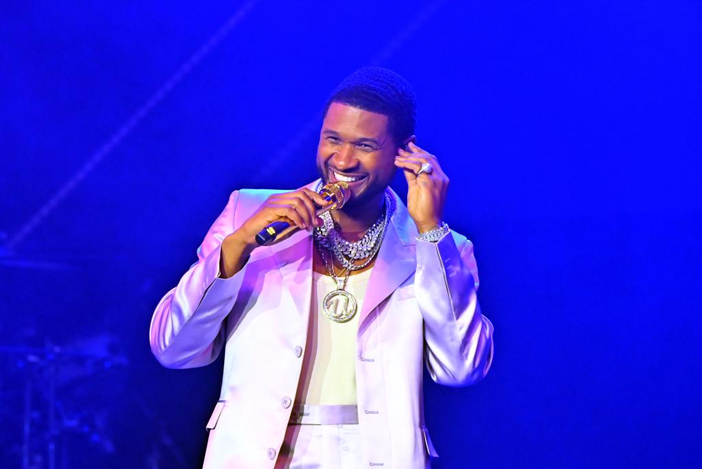 A photo of Usher on stage performing