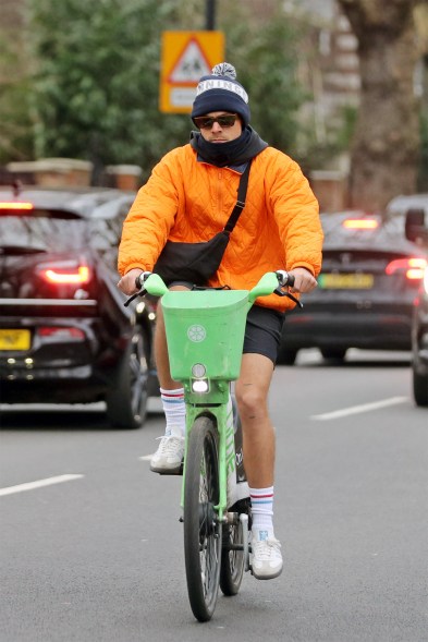 ORANGE YOU GLAD IT'S WINTER: On a birthday bike ride, Harry Styles is prepared for any kind of weather.