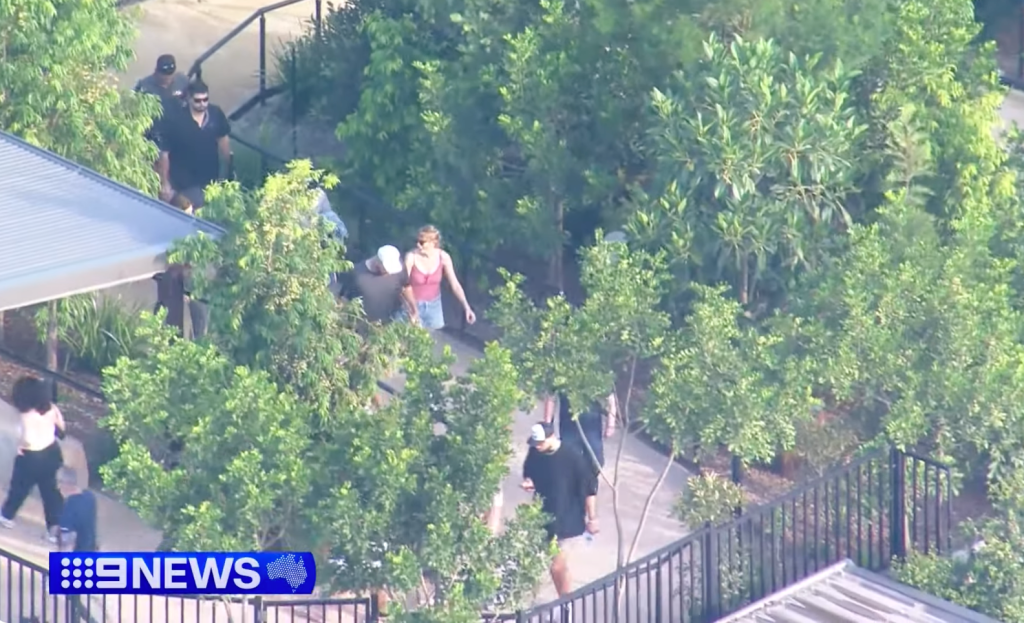 Travis Kelce and Taylor Swift walking around Sydney Zoo.